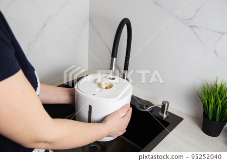 refilling the air freshener container with tap water. Air freshener. Copy space for text 95252040