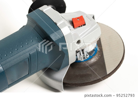 Modern angle grinder with red spindle lock button. Close-up, smooth start. 95252793