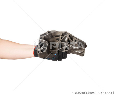 Aluminum engine cushion in the hand of a car mechanic on a white background, isolate. Engine mount replacement, close-up Aluminum engine cushion in the hand of a car mechanic on a white background, isolate. Engine mount replacement, close-up 95252831
