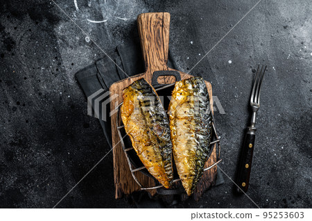 Grilled mackerel fish fillet on a grill. Black background. Top view Grilled mackerel fish fillet on a grill. Black background. Top view 95253603
