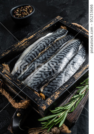Ready for cooking sliced raw mackerel fillet fish in a wooden box with herbs. Black background. Top view Ready for cooking sliced raw mackerel fillet fish in a wooden box with herbs. Black background. Top view 95253666