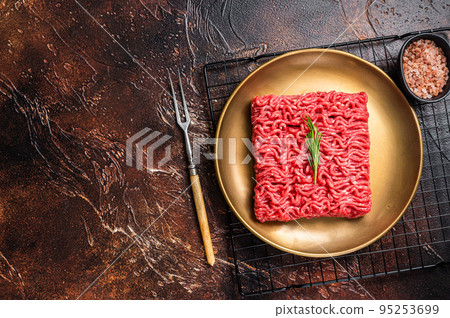 Fresh Raw mince beef, ground meat in a steel plate. Dark background. Top view. Copy Space Fresh Raw mince beef, ground meat in a steel plate. Dark background. Top view. Copy Space 95253699