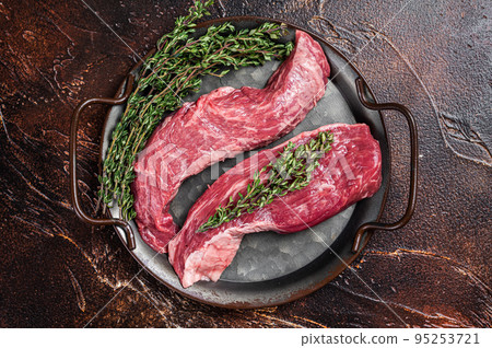 Raw Bavette or Sirloin flap beef meat steak with thyme. Dark background. Top view Raw Bavette or Sirloin flap beef meat steak with thyme. Dark background. Top view 95253721