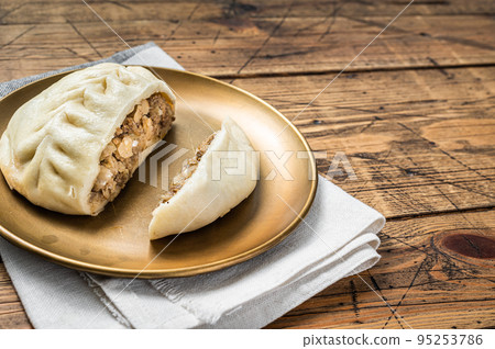 Wang Mandu Pyanse steamed pie stuffed with vegetable and meat Wooden background. Top view. Copy space 95253786