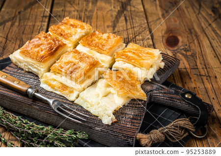 Delicious Turkish Tray pastry, Su boregi with cheese. Wooden background. Top view 95253889