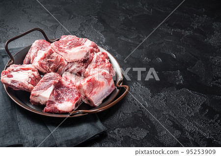 Raw diced beef and lamb marbled meat in kitchen steel tray. Black background. Top view. Copy space Raw diced beef and lamb marbled meat in kitchen steel tray. Black background. Top view. Copy space 95253909