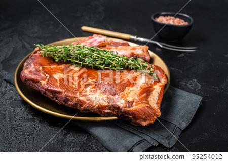 Grilled in BBQ Pork spare Ribs on steel plate with thyme. Black background. Top view 95254012