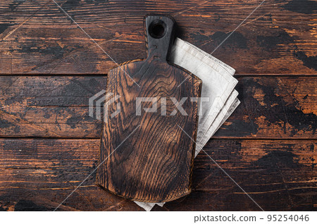 Empty wooden Cutting board over towel on kitchen table, healthy cooking background. Wooden background. Top view. Copy space 95254046