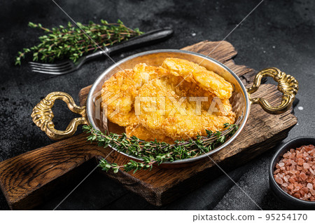 Fried Hash brown potato, hashbrown in a skillet. Black background. Top view Fried Hash brown potato, hashbrown in a skillet. Black background. Top view 95254170