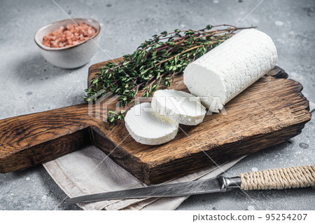 Fresh goat soft cheese with thyme. Gray background. Top view 95254207