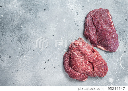 Traditional German raw beef cheeks on butcher table. Gray background. Top view. Copy space Traditional German raw beef cheeks on butcher table. Gray background. Top view. Copy space 95254347