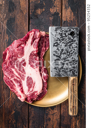 Raw marbled meat Steak on butcher table, uncooked beef chuck eye roll steak. Wooden background. Top view Raw marbled meat Steak on butcher table, uncooked beef chuck eye roll steak. Wooden background. Top view 95254352