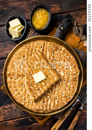 Crepes, Russian Blini with butter on a plate. Wooden background. Top view Crepes, Russian Blini with butter on a plate. Wooden background. Top view 95254359