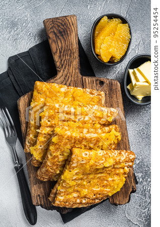 Thin Pancakes with Orange Sauce, French crepe Suzette. White background. Top view Thin Pancakes with Orange Sauce, French crepe Suzette. White background. Top view 95254454