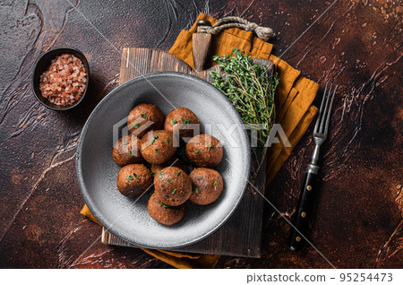 Vegetarian meatless Meatballs from plant based meat with herbs. Dark background. Top view 95254473