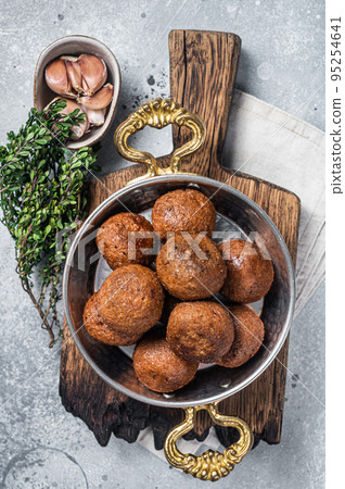 Roasted Vegan Lentil Meatballs in a skillet. Gray background. Top view Roasted Vegan Lentil Meatballs in a skillet. Gray background. Top view 95254641