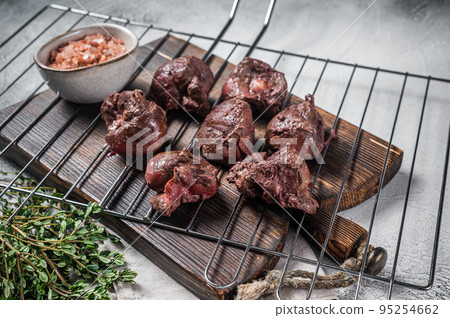 BBQ Grilled lamb mutton kidney, offal meat on grill. White background. Top view 95254662