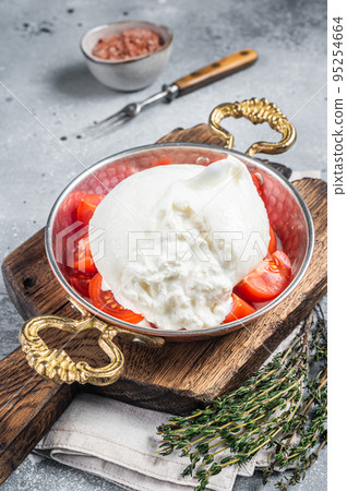 Burrata Italian cheese made from cream and milk of buffalo or cow. Gray background. Top view 95254664