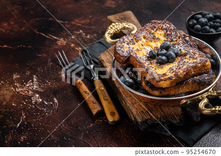 French toasts with maple sirup and Blueberry. Dark background. Top view. Copy space French toasts with maple sirup and Blueberry. Dark background. Top view. Copy space 95254670