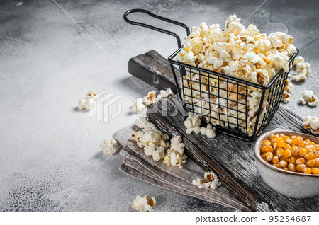 Homemade Buttered cheese popcorn in a basket. White background. Top view. Copy space Homemade Buttered cheese popcorn in a basket. White background. Top view. Copy space 95254687