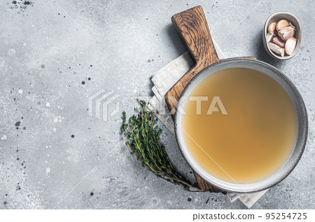 Bone meat chicken broth in a plate. Gray background. Top view. Copy space 95254725