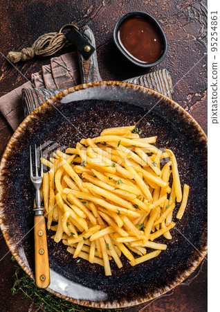 Homemade Baked Potato french fries in rustic palte with thyme. Dark background. Top view 95254861