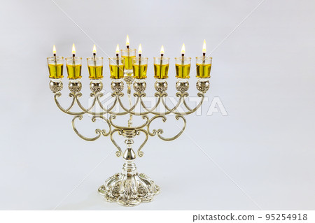 In this Hanukkah festival symbols are lit in menorah with Jewish holiday candles on white background with copy space In this Hanukkah festival symbols are lit in menorah with Jewish holiday candles on white background with copy space 95254918
