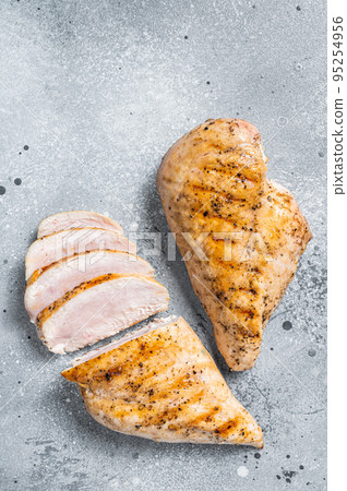 BBQ grilled and sliced chicken breast fillet steak. Gray background. Top view BBQ grilled and sliced chicken breast fillet steak. Gray background. Top view 95254956