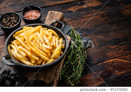 Skilet full of Potato french fries with salt. Wooden background. Top view. Copy space 95255092