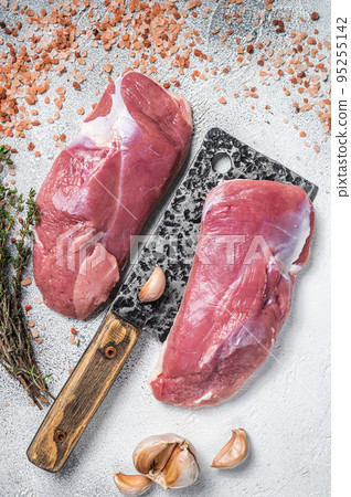 Fresh Raw Duck breast, fillet, poultry meat on butcher cleaver. White background. Top view Fresh Raw Duck breast, fillet, poultry meat on butcher cleaver. White background. Top view 95255142