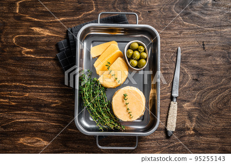 Fresh Halloumi sliced cheese in kitchen tray with thyme. Wooden background. Top view Fresh Halloumi sliced cheese in kitchen tray with thyme. Wooden background. Top view 95255143