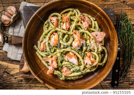 Italian traditional Pasta al Salmone, Bucatini pasta with Smoked Salmon. Wooden background. Top view Italian traditional Pasta al Salmone, Bucatini pasta with Smoked Salmon. Wooden background. Top view 95255505