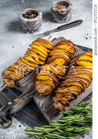 Crispy Tornado or twist potatoes chips on wooden board. Gray background. Top view 95255519