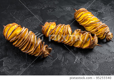 Twisted tornado potatoes chips. Black background. Top view Twisted tornado potatoes chips. Black background. Top view 95255540