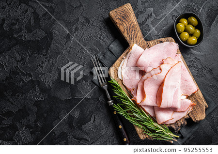 Pork ham slices on cutting board, Italian Prosciutto cotto. Black background. Top view. Copy space 95255553