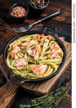 Salmon Bucatini pasta with creamy spinach sauce and fish fillet. Wooden background. Top view Salmon Bucatini pasta with creamy spinach sauce and fish fillet. Wooden background. Top view 95255591