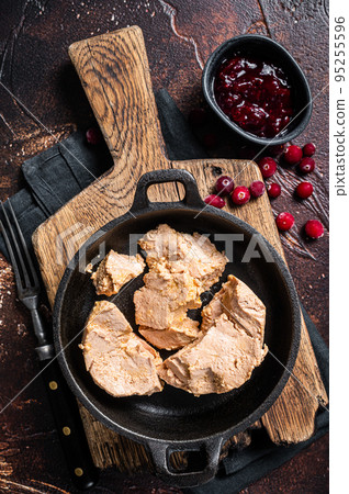 Franch Foie gras duck liver pate with lingonberry marmalade. Dark background. Top view Franch Foie gras duck liver pate with lingonberry marmalade. Dark background. Top view 95255596