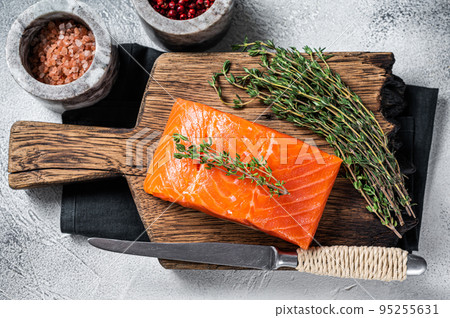 Fresh Raw salmon fillet steak on wooden board. White background. Top view Fresh Raw salmon fillet steak on wooden board. White background. Top view 95255631