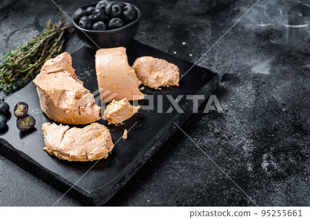 Foie gras duck liver pate and fresh blueberry. Black background. Top view. Copy space 95255661