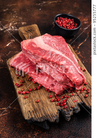 Raw sirloin beef cut, Silverside steak on a wooden board. Dark background. Top view 95255777