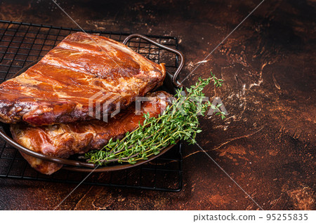 Smoked Barbecue Pork Ribs, Sparerib in kitchen tray. Dark background. Top view. Copy space Smoked Barbecue Pork Ribs, Sparerib in kitchen tray. Dark background. Top view. Copy space 95255835