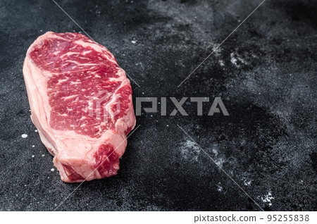 Raw Striploin steak, beef butchery cut. Black background. Top view. Copy space Raw Striploin steak, beef butchery cut. Black background. Top view. Copy space 95255838