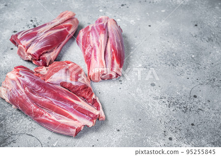 Uncooked Raw lamb shanks, mutton meat on kitchen table. Gray background. Top view. Copy space Uncooked Raw lamb shanks, mutton meat on kitchen table. Gray background. Top view. Copy space 95255845