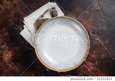 Table setting with vintage empty white plate on rustic wood. Dark background. Top view. Copy space Table setting with vintage empty white plate on rustic wood. Dark background. Top view. Copy space 95255924