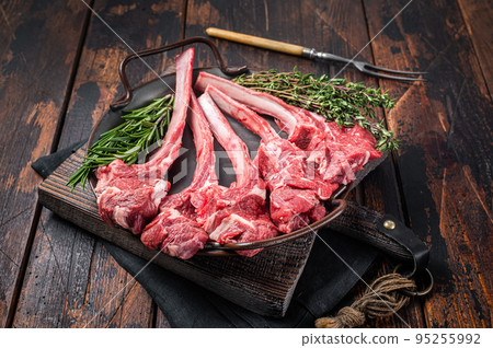 Fresh Raw Lamb chop steak in steel tray with herbs. Wooden background. Top view Fresh Raw Lamb chop steak in steel tray with herbs. Wooden background. Top view 95255992
