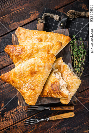 Baked samosa with chicken and cheese, samsa pies. Wooden background. Top view 95255993