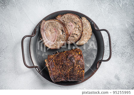 Sliced roast pork meat roulade on a steel tray. White background. Top view Sliced roast pork meat roulade on a steel tray. White background. Top view 95255995