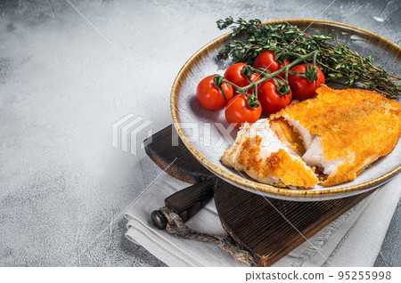 Crispy breaded tilapia filles on a plate with vegetables. White background. Top view. Copy space Crispy breaded tilapia filles on a plate with vegetables. White background. Top view. Copy space 95255998