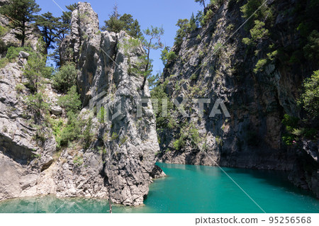 View of the lake with clear turquoise water and on the mountain cliffs of the Green Canyon. Manavgat, Antalya, Turkey View of the lake with clear turquoise water and on the mountain cliffs of the Green Canyon. Manavgat, Antalya, Turkey 95256568