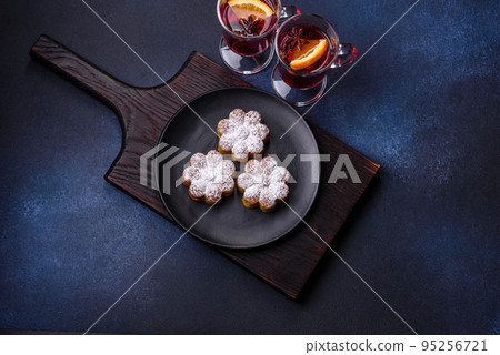 Hot mulled wine with a slice of orange, with cinnamon, cloves and other spices Hot mulled wine with a slice of orange, with cinnamon, cloves and other spices 95256721